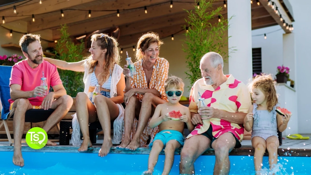 International Timeshare Appreciation Day: a multi-generational family sitting at the edge of a pool