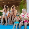 International Timeshare Appreciation Day: a multi-generational family sitting at the edge of a pool