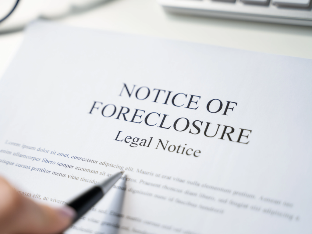 A close-up of a legal notice of foreclosure being reviewed, often caused by unpaid timeshare maintenance fees.