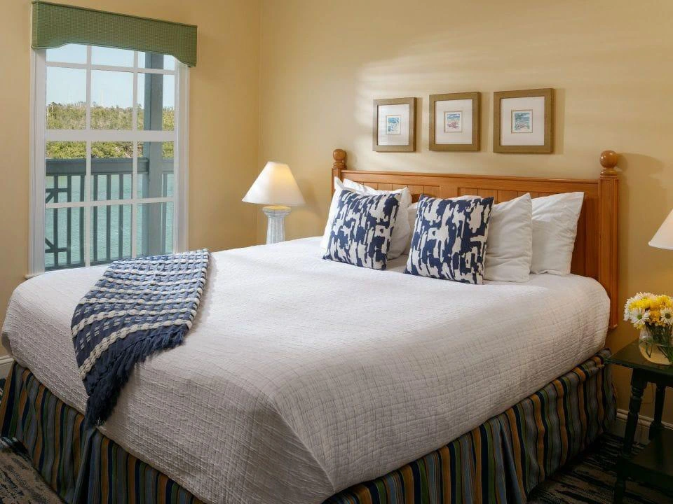 King bedroom with a balcony overlooking the water at Hyatt Beach House, funded by timeshare maintenance fees.