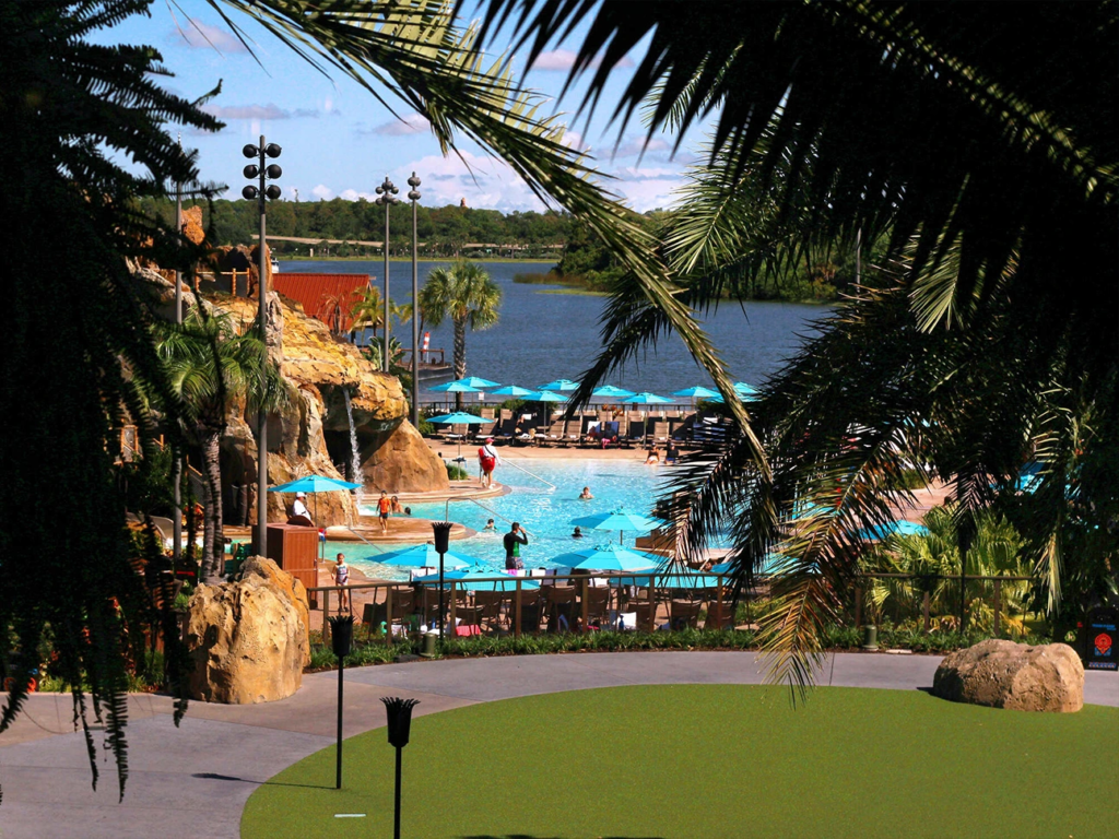The outdoor swimming pool and volcano slide at Disney's Polynesian Village Resort overlooking the lagoon.