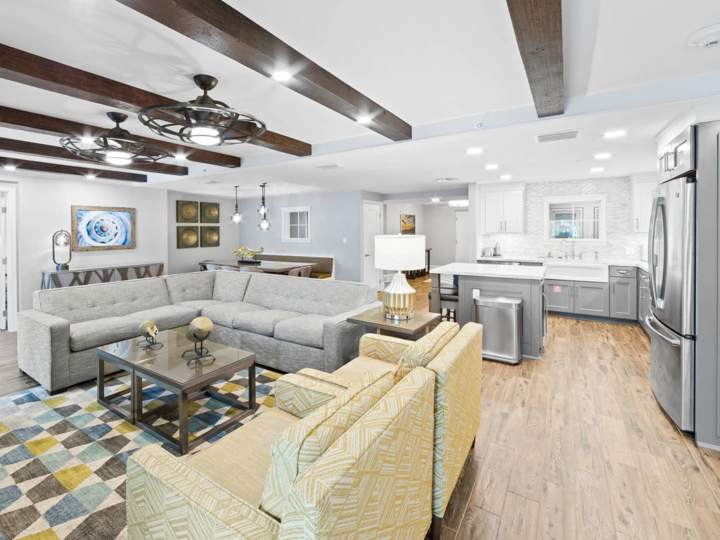 A modern, open-concept luxury living room and kitchen suite at a Cape Canaveral beach resort.