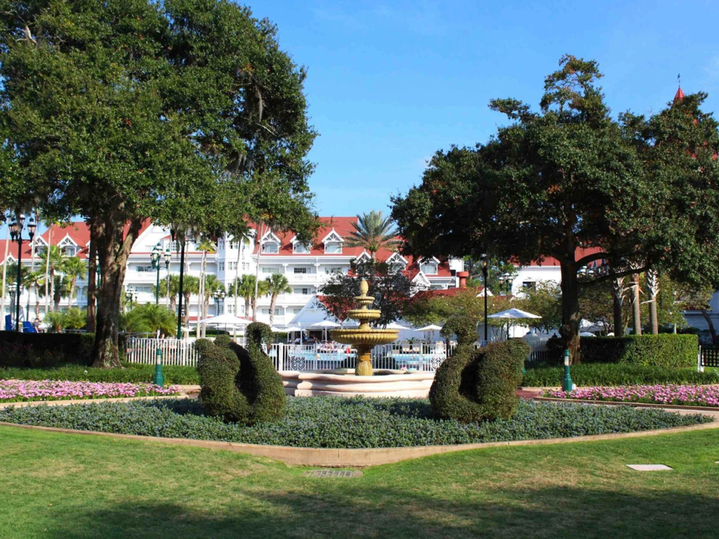 Swan-shaped topiaries and a multi-tiered fountain in the garden at Disney's Grand Floridian Resort.