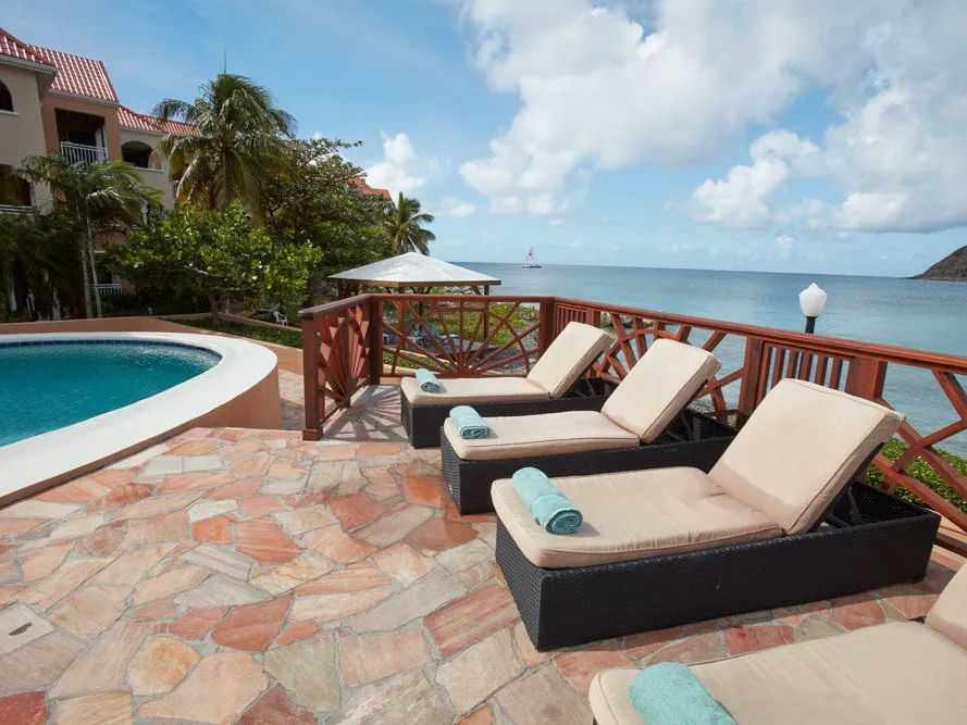 Sun loungers overlooking the sea at Divi Little Bay Beach Resort