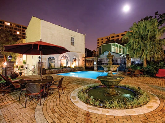 Nighttime pool and fountain courtyard, a beautiful setting to ponder the Pros and Cons of Wyndham Timeshare at Avenue Plaza.