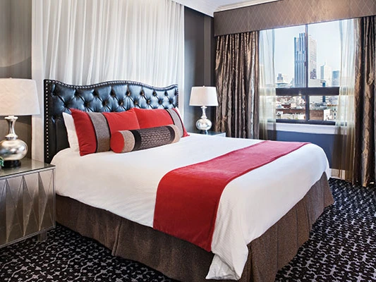 Bedroom with city view at Canterbury Resort, ideal for those weighing the Pros and Cons of Wyndham Timeshare.