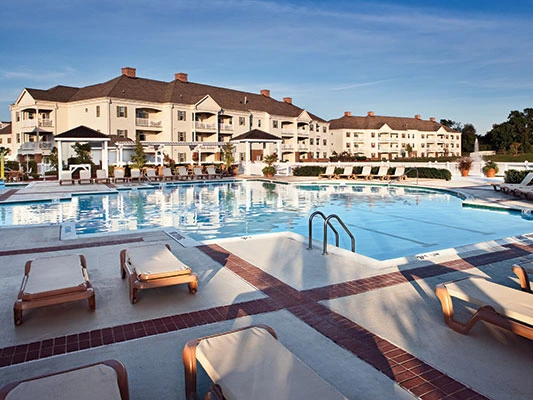Large outdoor pool and lounge chairs at Governor's Green Resort.