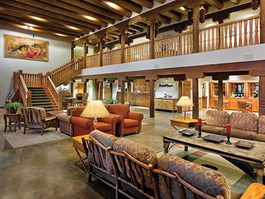 Southwestern-style lobby with exposed log beams and rustic decor at Taos Resort.