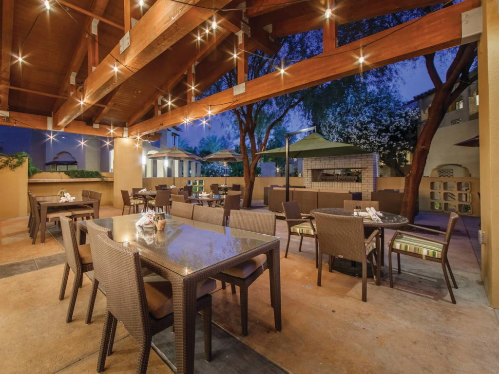Covered outdoor dining with string lights at Scottsdale Resort. Consider the Pros and cons of Holiday Inn Vacation Club here.