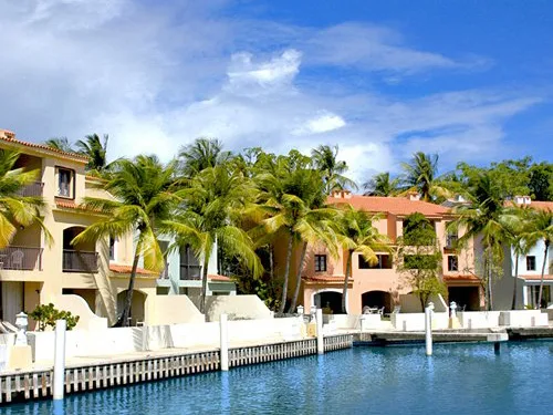 Waterfront villas with private docks, palm trees, and colorful stucco facades at RCI resorts in Puerto Rico.