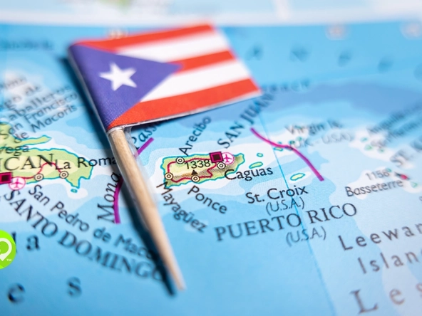 Puerto Rico flag pin marking the island on a map, with Santo Domingo and the Leeward Islands visible nearby.
