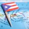 Puerto Rico flag pin marking the island on a map, with Santo Domingo and the Leeward Islands visible nearby.