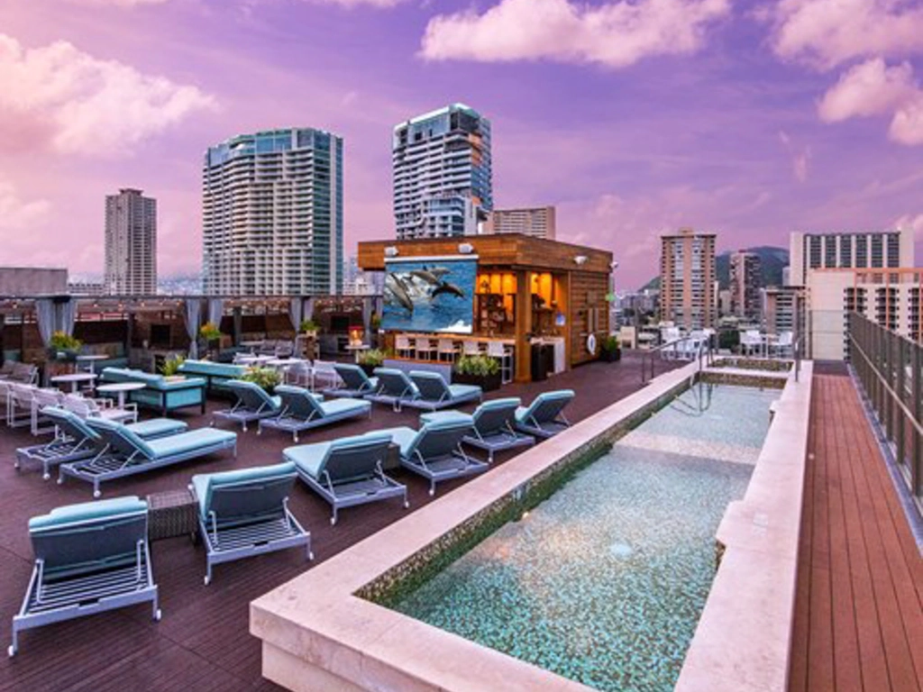 Luxury rooftop deck pool and lounge chairs at Hokulani Waikiki.
