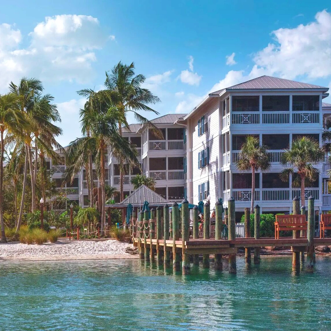 waterfront timeshare resort with palm trees and a boat dock