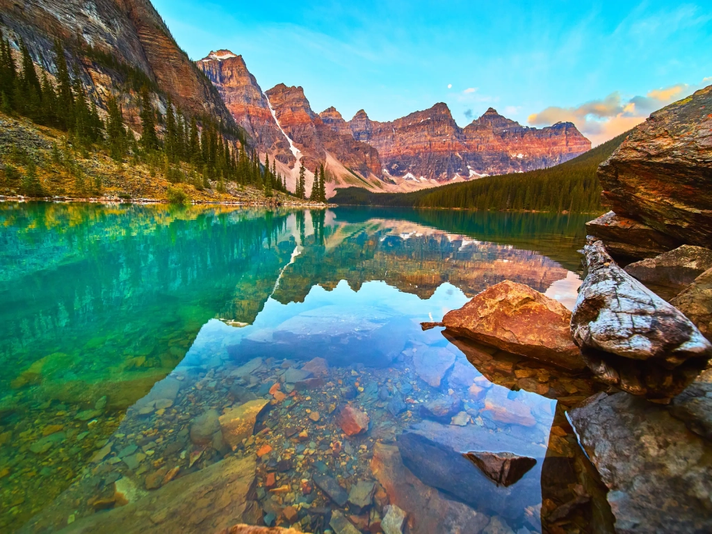 Crystal-clear turquoise lake and mountain peaks—a perfect setting for Romantic Getaways amid evergreen forests.