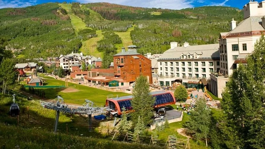 Aerial summer view of Hyatt Vacation Club at Beaver Creek resort with gondola, hotels, and green slopes under blue sky.
