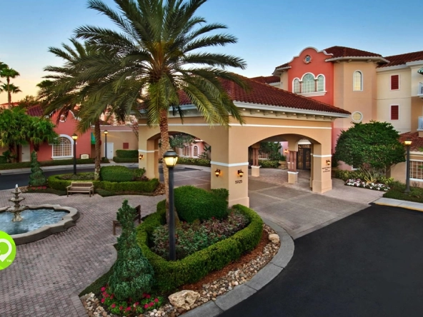 Dusk at the entrance to Marriott's Grande Vista, a Marriott timeshare points chart resort, with palms and a stone fountain.