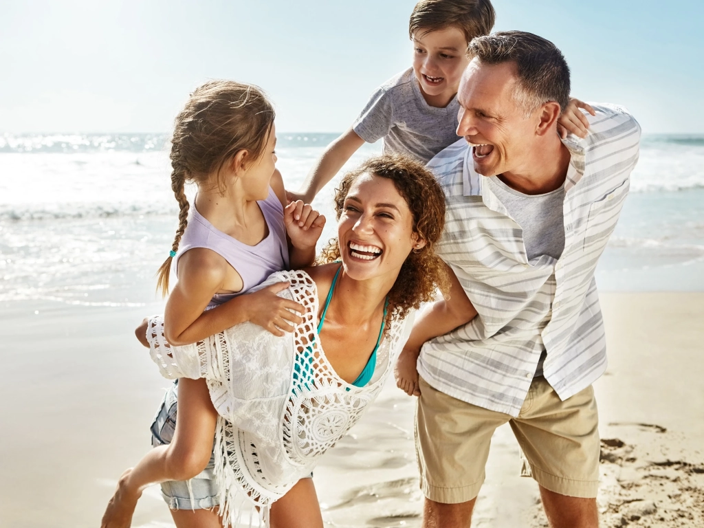 Happy family on the beach during a vacation on a budget