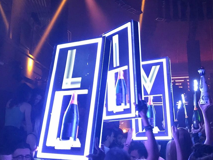 Lit-up LIV letter signs during bottle service at LIV Nightclub