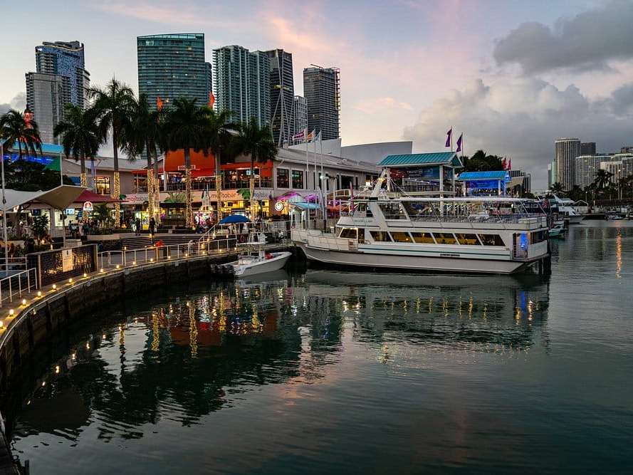 Boats at the Bayside Marketplace marina with the downtown Miami skyline at dusk