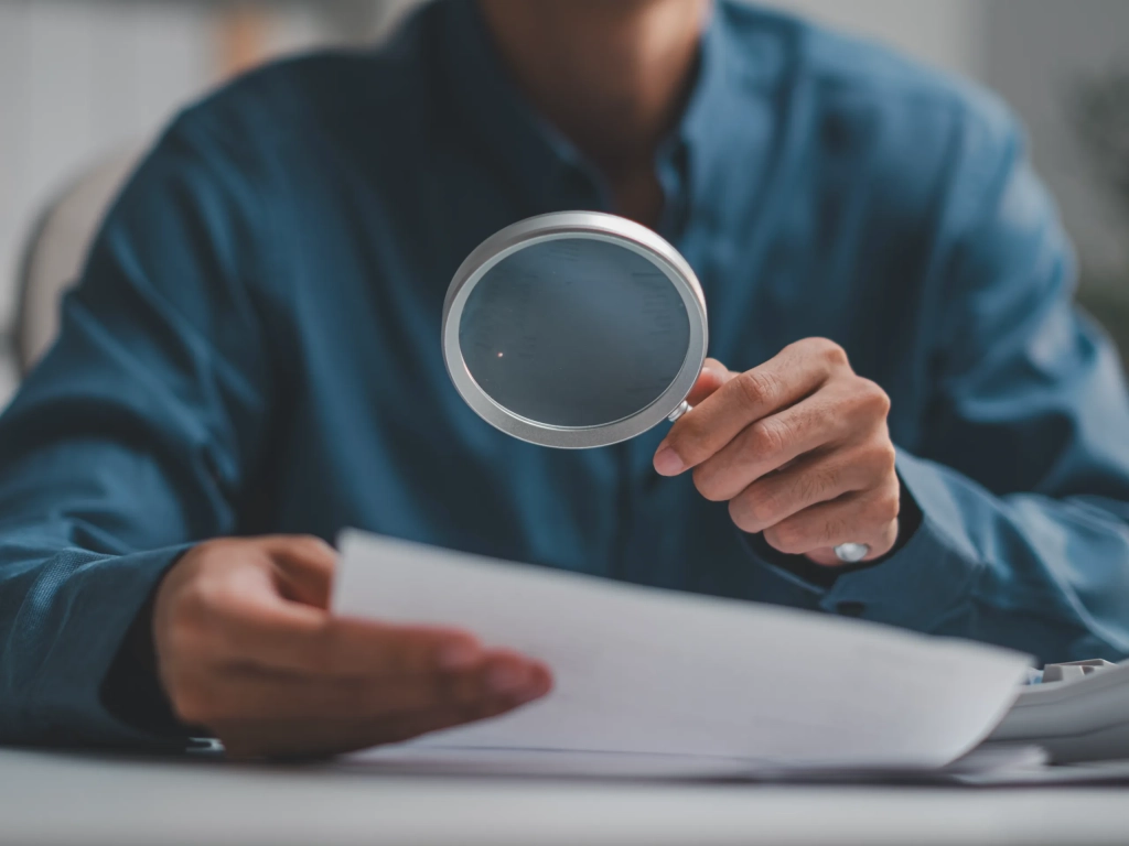 Checking paperwork with a magnifying glass before selling my timeshare