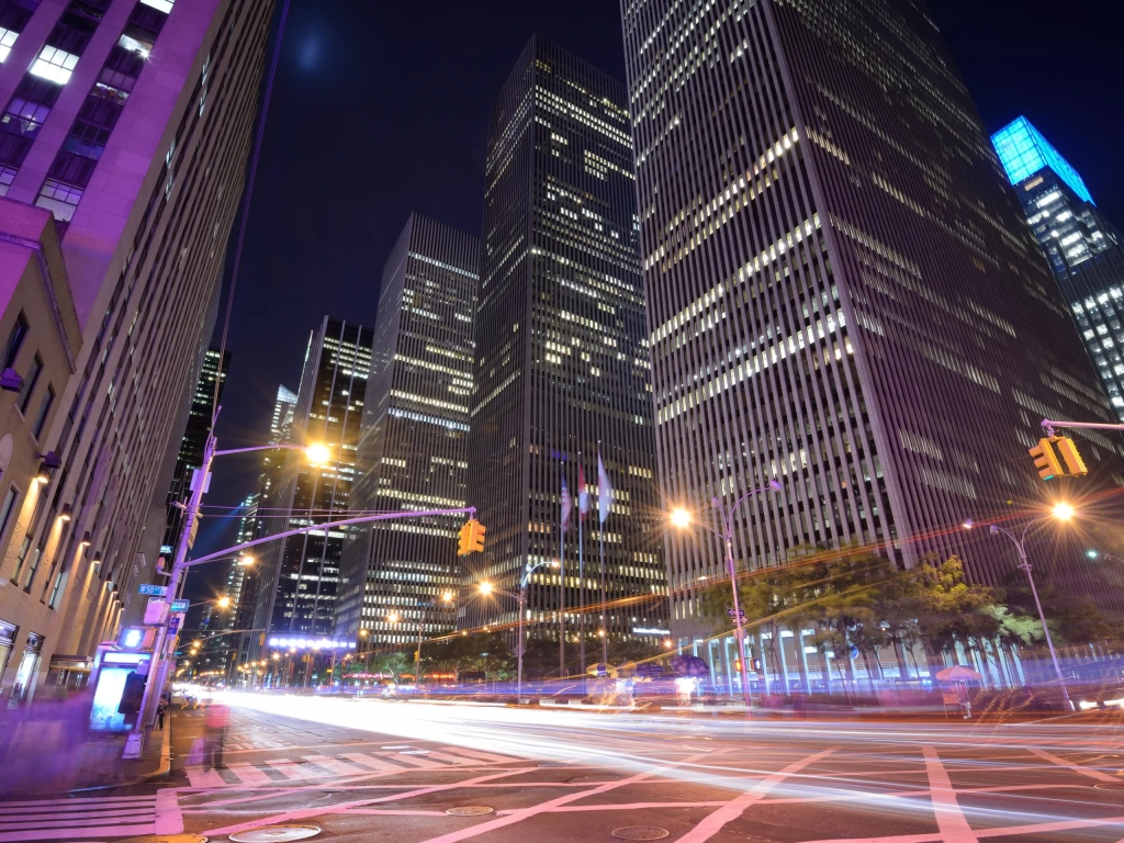 Light trails through a busy Manhattan intersection at night