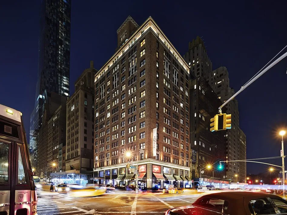 Exterior of The Quin, a Hilton Club, at night, one of the timeshares New York City offers