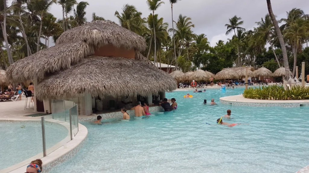Swim-up bar under a palapa at Grand Palladium Punta Cana