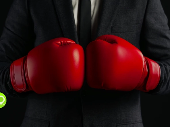 Welk Vs Timeshare Exit Companies Hero: Man in suit wearing boxing gloves